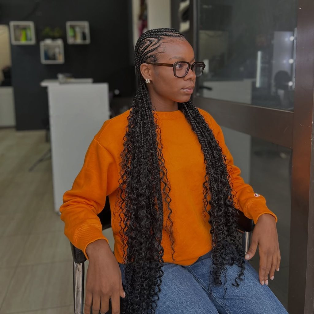 Cornrows styled with loose curls for a textured look
