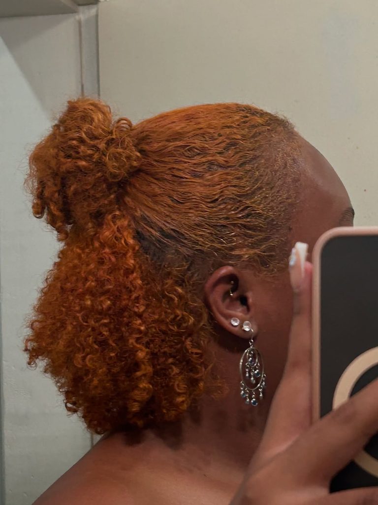 Half-up half-down hairstyle on Black woman with natural curls