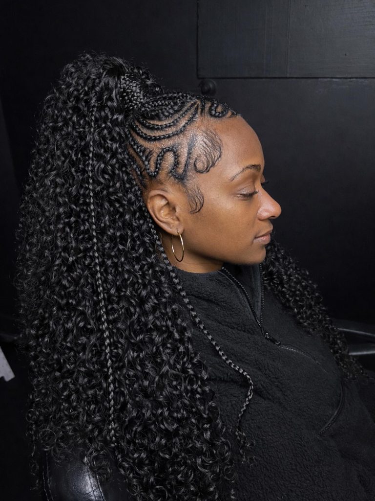 Intricate braided ponytail with sleek cornrows and a full curly textured ponytail