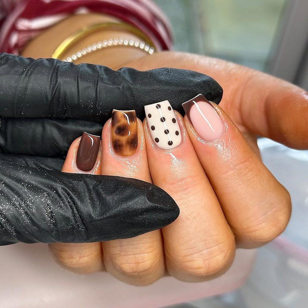 Short square nails with milk chocolate, tortoiseshell, cream polka dots, and chocolate French tip