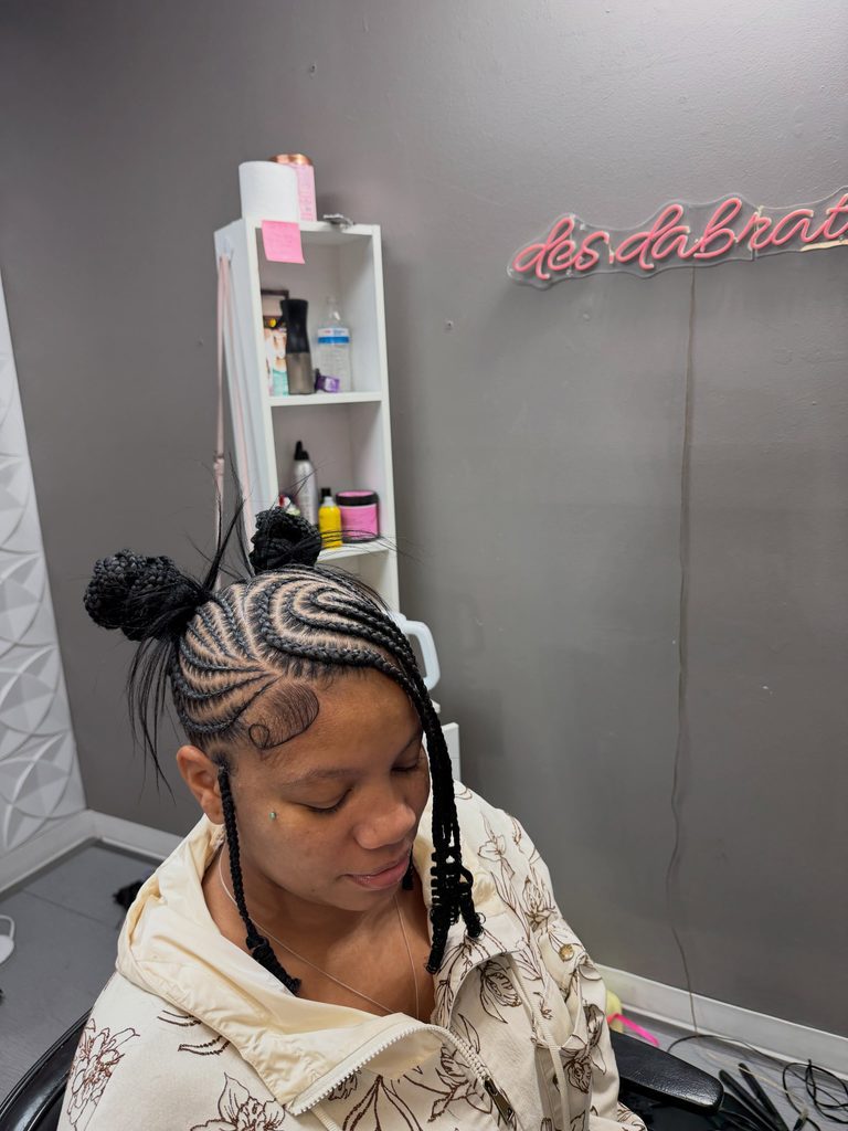 Braided hairstyle with two high buns, curved feed-in braids, and face-framing braids
